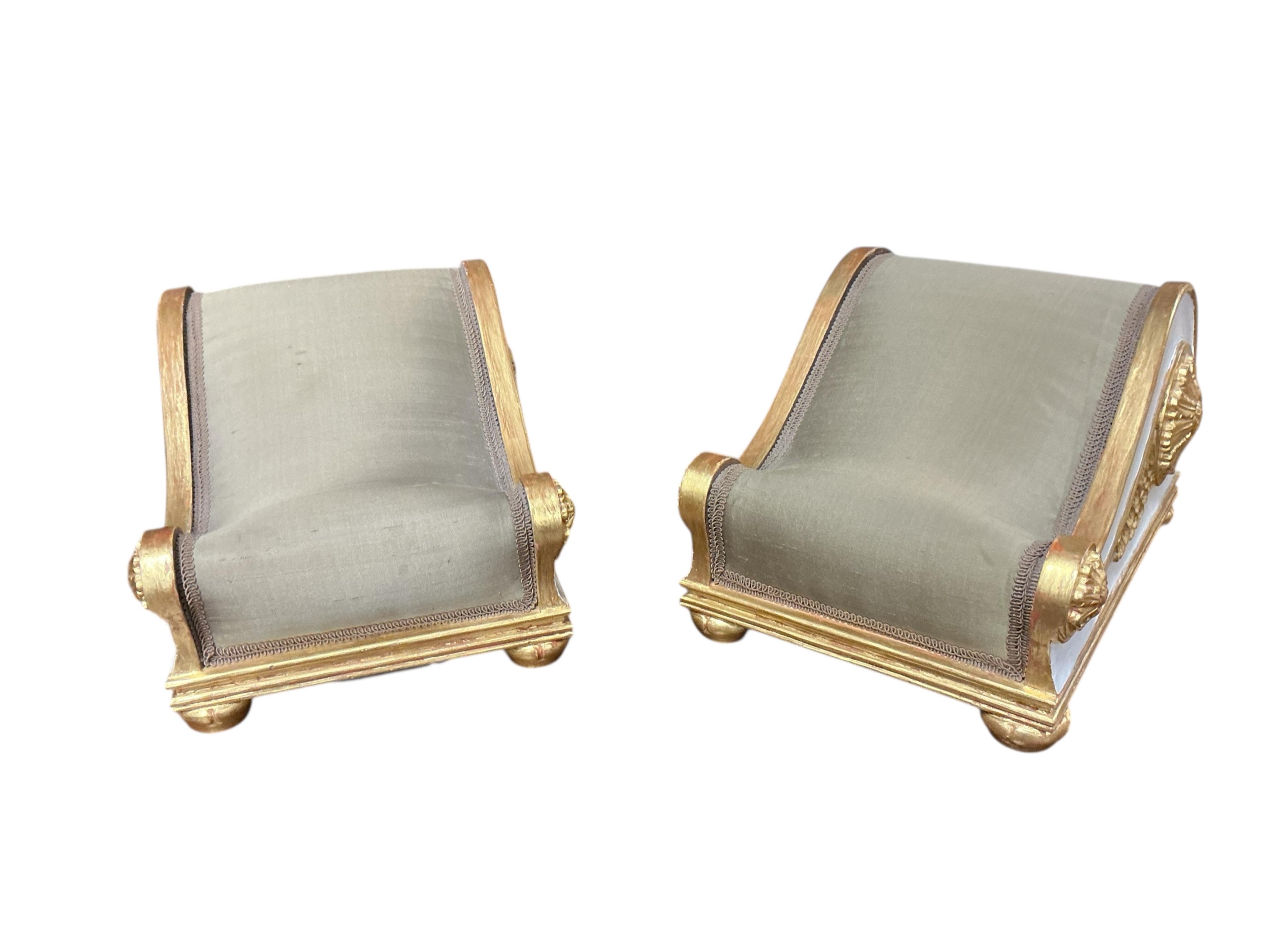 A pair of Regency style painted upholstered footstools, width 28cm, depth 36cm, height 22cm